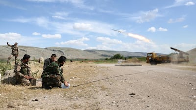 A Syrian fighter from the Turkish-backed Al Hamza division takes a selfie with his mobile telephone as fellow fighters fire a missile from Syria's rebel-held Aleppo province toward regime-held areas. AFP