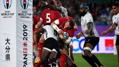 Wales' full back Liam Williams (C) is tackled by Fiji's scrum-half Frank Lomani (L) during the Japan 2019 Rugby World Cup Pool D match between Wales and Fiji at the Oita Stadium in Oita. AFP
