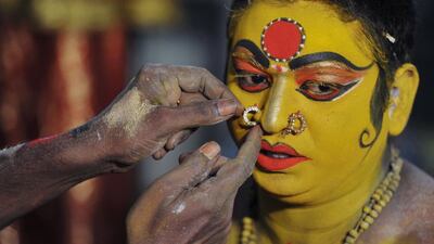 Indian artist Korakula Munesh gets ready to perform as the Hindu goddess Maha Kali during the Bonalu festival in Hyderabad. Noah Seelam / AFP Photo