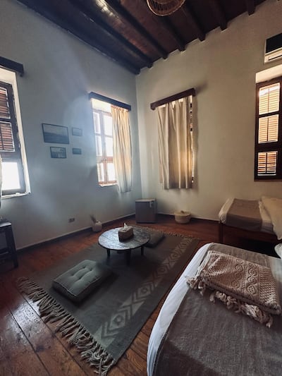 One of the hotel's six guest rooms, with the original wooden ceiling beams and shutters preserved through the late-1990s restoration. Photo: El Quseir Hotel