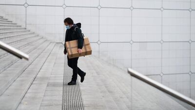 A lone rush hour morning commuter on the steps of the Grande Arche monument in the La Defense business district in Paris, France. Bloomberg