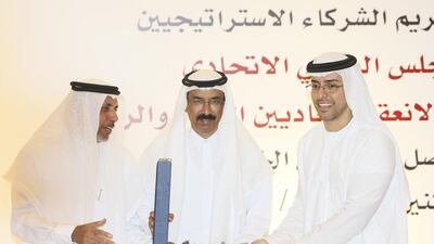 Dr Mohammed Al Mazrouei, General Secretary of the FNC, and Mohammed Al Murr, the council’s Speaker, present Mohammed Al Otaiba, Editor-in-Chief of The National, with the award in Abu Dhabi. Sarah Dea / The National