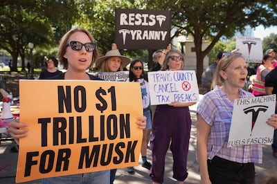 People protest outside the Texas state Capitol in Austin, before Tesla approved a $1 trillion pay package for chief executive Elon Musk. AP