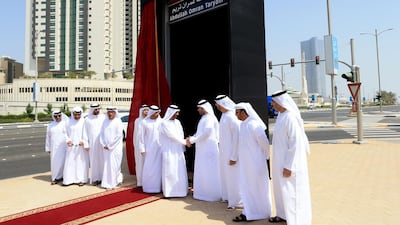 Saeed Al Ghafli, fifth from right, chairman of the Department of Municipality Affairs, greets Khalid Abdullah Omran after Inaugurating the street on Al Reem Island in Abu Dhabi to honour his father Abdullah Omran Taryam. Ravindranath K / The National