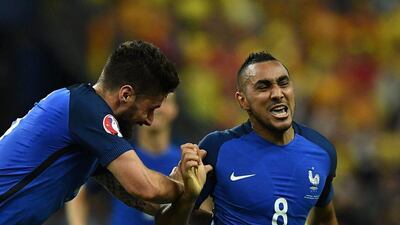 France forward Dimitri Payet (R) celebrates with France’s forward Olivier Giroud after scoring the 2-1 during the Euro 2016 group A football match between France and Romania at Stade de France, in Saint-Denis, north of Paris, on June 10, 2016. Franck Fife / AFP