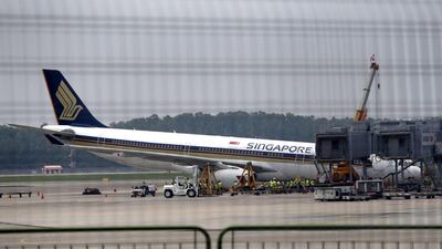 A Singapore Airlines Airbus A330-300 is seen collapsed at Changi Airport in Singapore. Wee Teck Hian / Mediacorp via AP