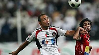 Al Jazira's Brazilian striker Fernando Baiano, left, under pressure from Al Ahli's Khaled Mohammed, scored his 18th goal of the season.