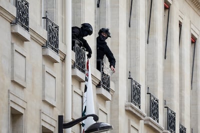 Police remove a protest banner at Sciences Po university, in Paris. Reuters
