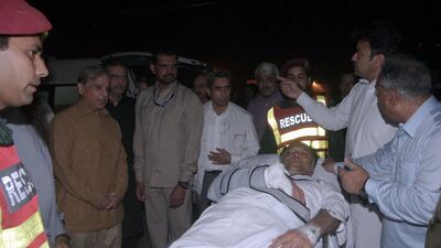 Officers and rescue workers move Pakistan's Interior Minister Ahsan Iqbal on a stretcher, after he was shot during a rally in Narowal on May 6, 2018. Directorate General Public Relations Punjab handout / Reuters