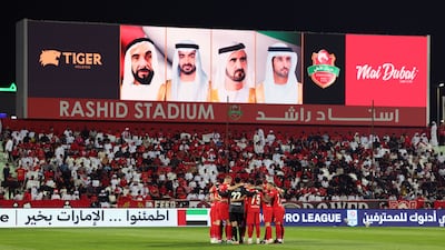 Shabab Al Ahli players during a team huddle.