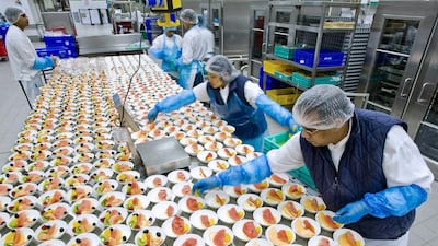 Staff at Emirates Flight Catering prepare dishes at their facilities in Dubai. Charles Crowell for The National