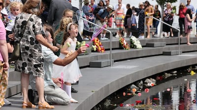 A family member of one of the 185 victims blows bubbles over the Avon River during the national memorial service. Getty Images