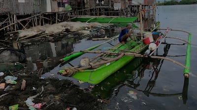 A fisherman folds a fishing net on Christmas day in Bacoor city, Philippines. EPA