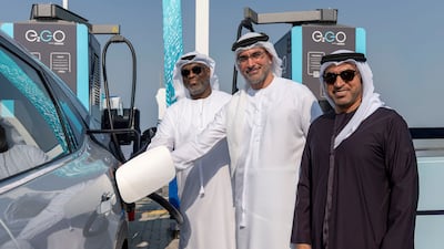 Officials from Adnoc Distribution attend the launch of the superfast EV charging station on the E11 motorway between Abu Dhabi and Dubai. Photo: Adnoc Distribution