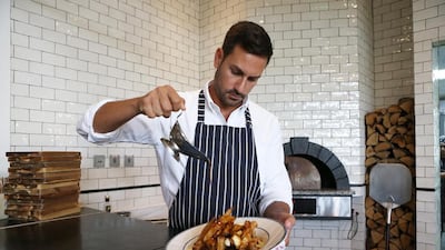 Joey Ghazal, founder and managing partner of The Maine Oyster Bar & Grill in Dubai, prepares poutine. Pawan Singh / The National