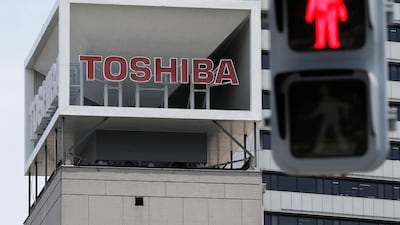 The logo of Toshiba next to a traffic signal in Tokyo. The company said it will drop two existing directors from its board amid shareholders calls for accountability. Reuters