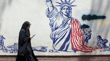 A woman walks past an anti-US mural next to the former US embassy in Tehran, Iran, 09 July 2026. Iran and the US exchanged fire after US President Trump said that the ceasefire is 'over'. EPA/ABEDIN TAHERKENAREH RESTRICTIONS: NO Access Israel Media/Persian Language TV Stations Outside Iran/Strictly No Access BBC Persian/VOA Persian/Manoto TV/Iran International TV. (As mandated by Iran's Directorate General for Foreign Media) --