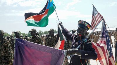 A supporter with US and South Sudan flags during the graduation ceremony for new members of the unified forces at Dr John Garang Mausoleum in Juba on August 30, 2022. AFP