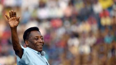 Former Brazilian footballer Pele greets the crowd before the start of the Under 17 boys final match of the Subroto Cup in New Delhi on Friday. Money Sharma / AFP