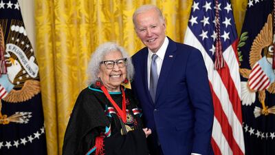 Mr Biden presents the 2021 National Humanities Medal to Native American activist Henrietta Mann. AP