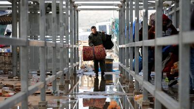A Palestinian working in Israel heads to work with others through a border checkpoint. Reuters