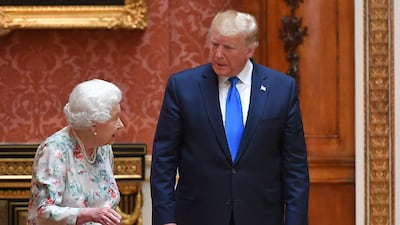 Britain's Queen Elizabeth II (L) views a display of US items of the Royal collection with US President Donald Trump at Buckingham palace at Buckingham Palace in central London. AFP