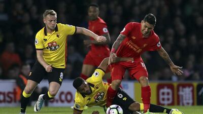 Liverpool, in red, are looking good for Uefa Champions League qualification. John Walton / AP Photo