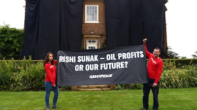 Greenpeace activists on the roof of UK Prime Minister Rishi Sunak's manor house in Kirby Sigston, northern England, to protest at his backing for new oil and gas licences in the North Sea. AFP