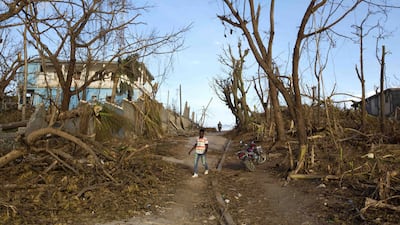 A man walks past debris left by Hurricane Matthew in Dame-Marie, Haiti. AP Photo/Dieu Nalio Chery