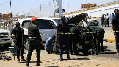 Security personnel stand near a car damaged after an explosion targeting the motorcade of Sudan's Prime Minister Abdalla Hamdok near the Kober Bridge in Khartoum, Sudan. Reuters