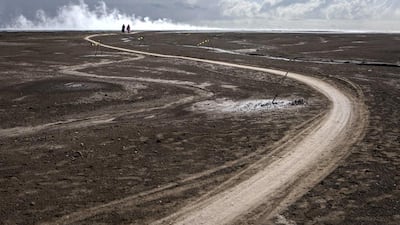 Visitors watch steam coming out of the mudflow that the energy firm Lapindo Brantas blames on a 6.3 magnitude earthquake which struck the neighbouring city of Yogyakarta, 150 miles west of a company drill site in Sidoarjo, two days before the eruption in 2006. Ulet Ifansasti / Getty Images