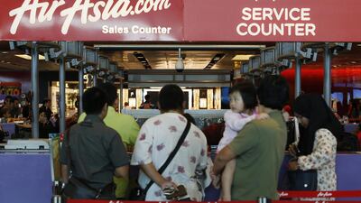People queue at an AirAsia counter at Changi Airport in Singapore on Sunday. Indonesia’s Transport Ministry official Hadi Mustofa said an AirAsia aircraft, flight number QZ 8501from Indonesian city of Surabaya to Singapore, lost contact with the Jakarta air traffic control tower on Sunday at 6:17 a.m local time. Edgar Su / Reuters