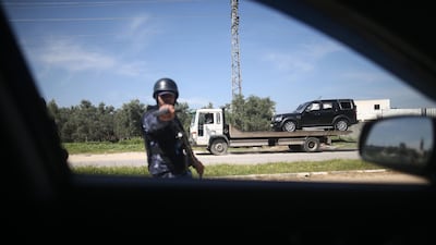 One of the cars of the Palestinian Prime Minister's convoy that was hit by an explosion being towed away to the Gaza strip Erez crossing, in Beit Hanun, the northern access point into the coastal Palestinian territory. Mohammed Abed / AFP