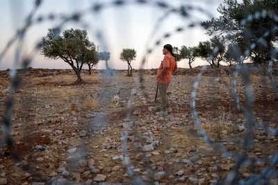 An activist witnesses Israeli settlers in the Kaabneh Bedouin community east of Taybeh, in the occupied West Bank. AFP