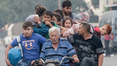 Palestinians flee after Israeli strikes in the northern and eastern Gaza Strip on Sunday. EPA