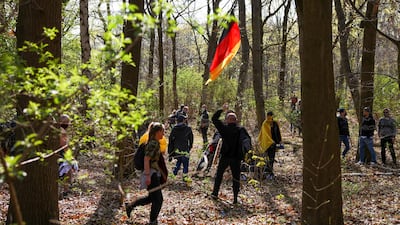 People walk towards the Reichstag building through Tiergarten Park in Berlin, during a protest against the government measures. Reuters