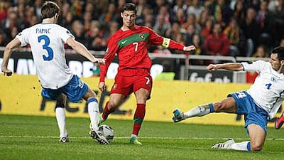 Cristiano Ronaldo takes on two Bosnian defenders. The Portugal captain scored twice in their 6-2 win to advance to the Euro 2012 finals.