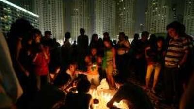 Iranians light candles to protest against the election of Iran's president, Mahmoud Ahmadinejad, at Jumeirah Beach Residence last night.