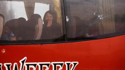A bus with Syrian rebels and their families aboard leaves Wafideen camp in Douma, Syria, on April 9, 2018. Omar Sanadiki / AFP