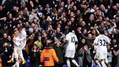 Gareth Bale, left, celebrates scoring the opening goal with Gylfi Sigurdsson as more of their Tottenham Hotspur teammates run to join them.