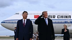 US President Donald Trump, right, with Chinese President Xi Jinping at Joint Base Andrews in Maryland. Mr XI is on an official visit to the US. AFP