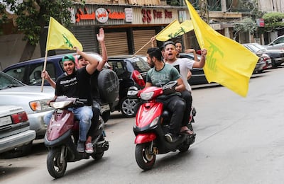 Hezbollah supporters carry their party flags and ride motorcycles in southern Beirut, Lebanon, on May 6, 2018. Nabil Mounzer / EPA Photo