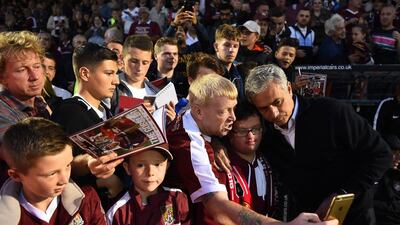 Manchester United manager Jose Mourinho poses for selfie photographs with Northampton Town fans. Laurence Griffiths / Getty Images