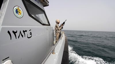 A Saudi border guard watches as he stands in a boat off the coast of the Red Sea on Saudi Arabia's maritime border with Yemen, near Jazan April 8, 2015. Reuters