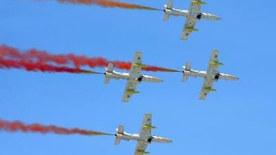 The Knights streak red smoke through the air during their performance in Al Ain.