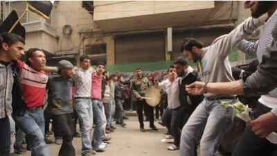 Demonstrators dance on Friday during a protest marking two years since the start of the uprising against the Assad regime.