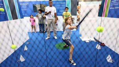 Children test their tennis skills at Marina Mall in Abu Dhabi yesterday. Rich-Joseph Facun / The National