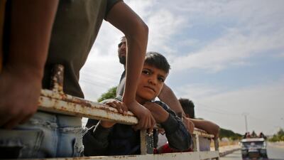 Syrians return to their homes in the town of Ayn al-Arus, south of the border town of Tal Abyad, after it was taken over by Turkish-backed Syrian fighters during their assault on Kurdish-held border towns in northeastern Syria. Syrian regime forces moved towards the Turkish border after Damascus reached a deal with beleaguered Kurdish forces following a US withdrawal announcement, AFP correspondents reported. AFP