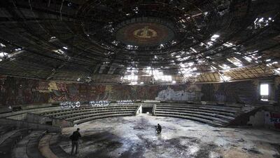 Photographers take pictures inside the crumbling main hall of the Memorial House of the Bulgarian Communist Party on mount Buzludzha. The monument was officially opened in 1981 by the Bulgarian Communist regime to mark 100 years of the set up of an organised Socialist movement, a predecessor of the Bulgarian Communist Party. Stoyan Nenov / Reuters