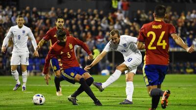 Harry Kane shoots past Gerard Pique. Mike Hewitt / Getty Images